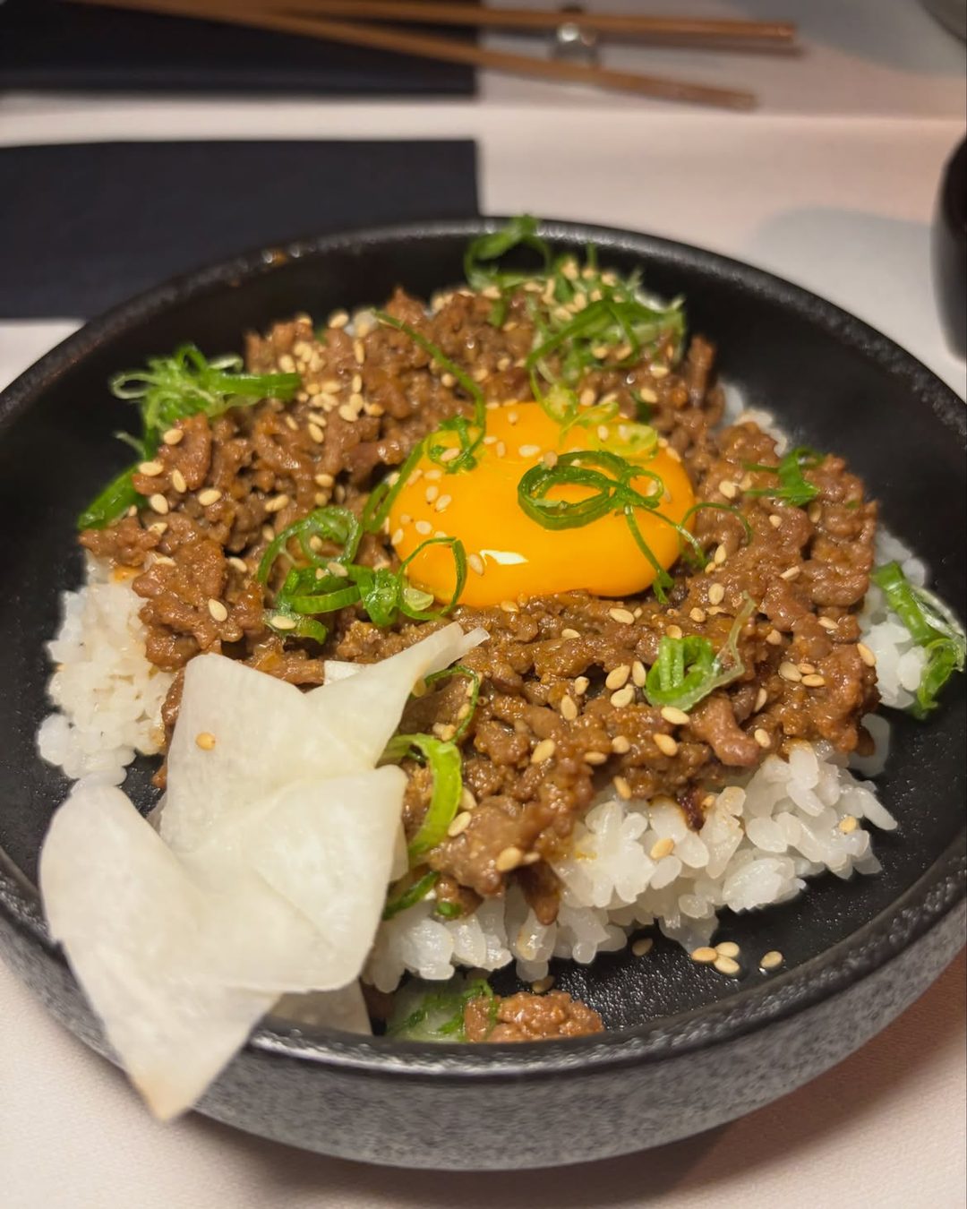 Gyudon with a raw egg yolk, spring onion and daikon